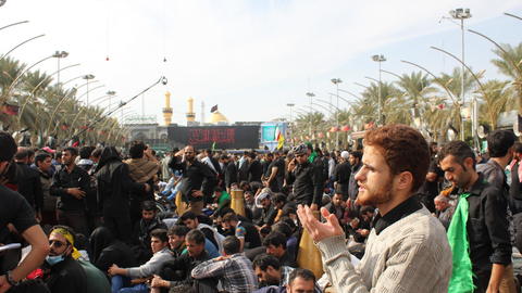 man clapping in a crowd of people