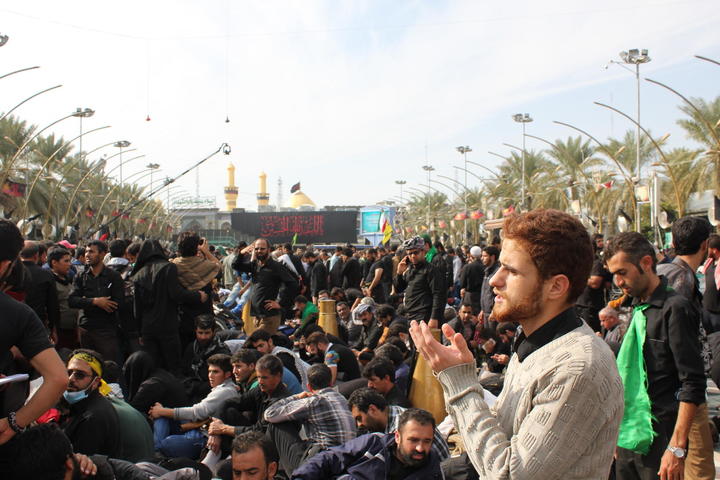 man clapping in a crowd of people
